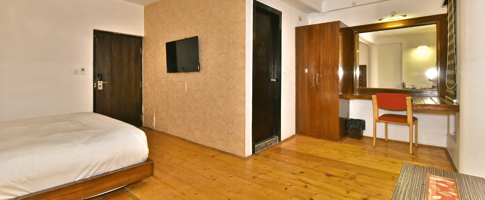 Living area of the suite with wooden-finished flooring at DLS Hillcrest Resort, Shimla.